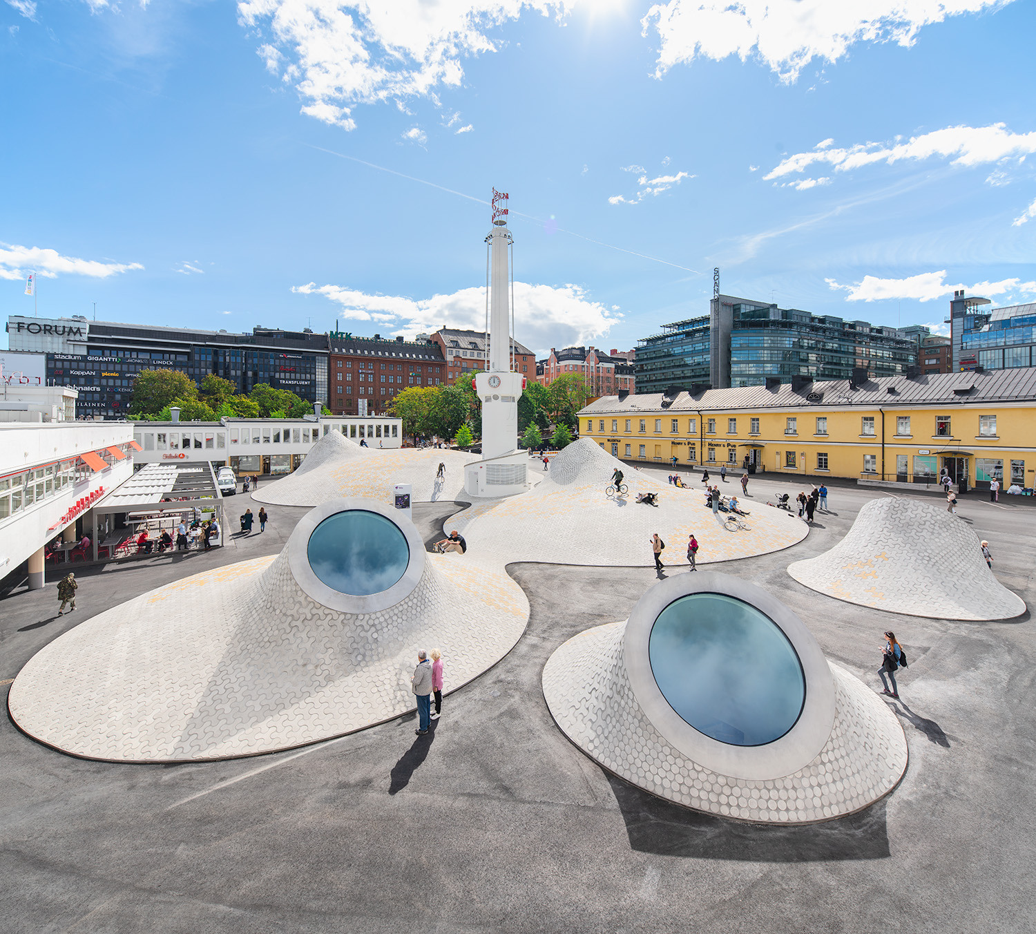 people on a terrace, skating and cycling in an urban setting